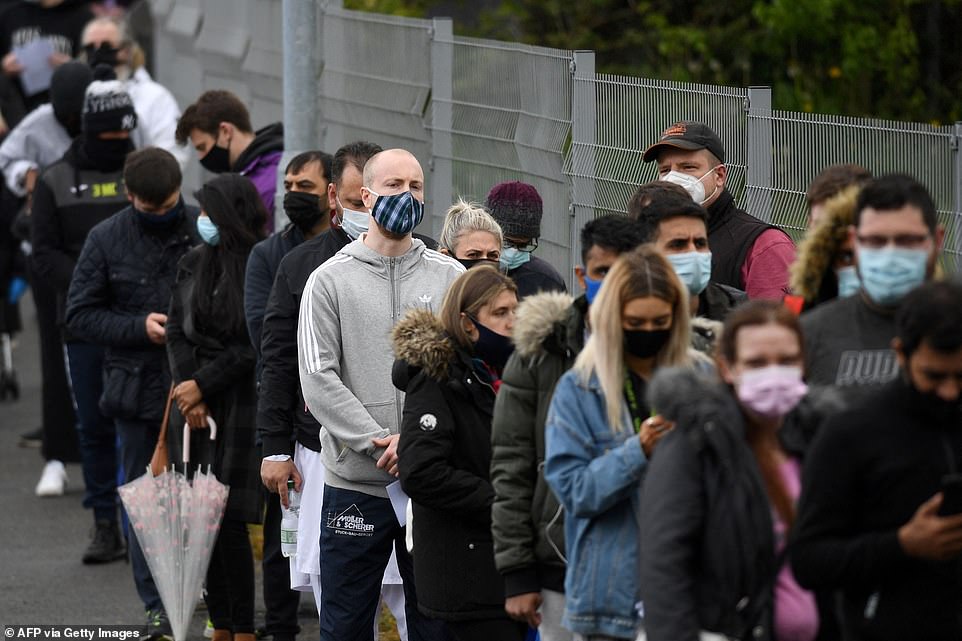 Members of the public in Bolton are pictured queueing for coronavirus vaccines after local health chiefs did away with NHS guidance and said any adult could get a jab – the Government has asked the council and NHS not to break from national policy