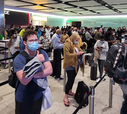 Heathrow travellers have told MailOnline how they were 'terrified of catching Covid' while being crammed into the airport's border hall this morning. Pictured: Passengers queue at the Heathrow border hall today